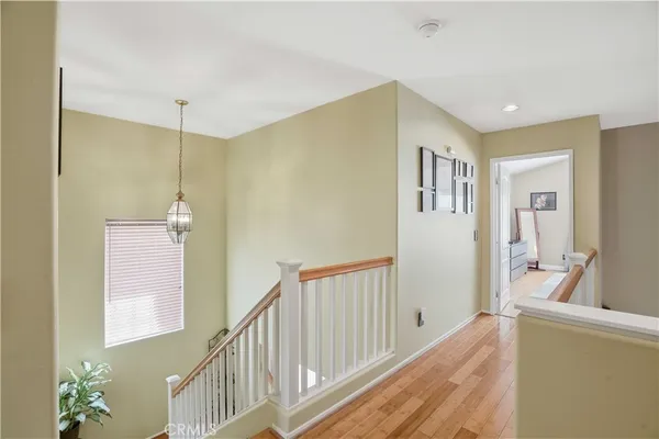 a view of a hallway with windows and entryway