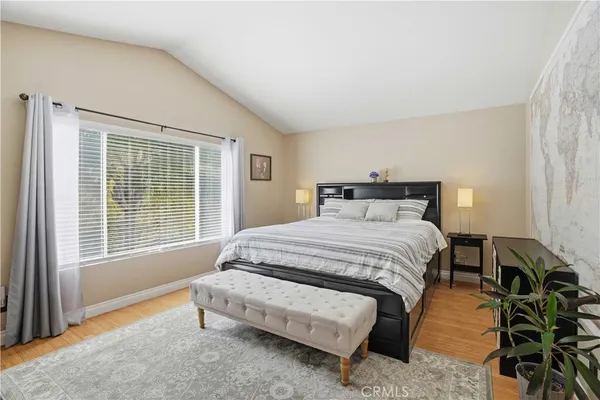 a bedroom with a bed and a window