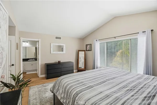 a bedroom with a large bed and a window