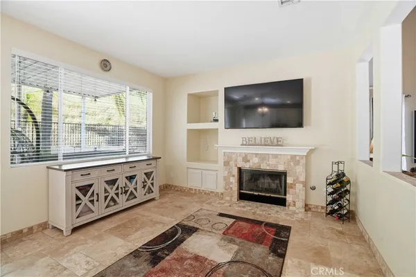 a living room with furniture a fireplace and a flat screen tv