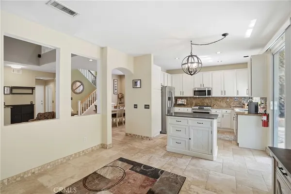 a large kitchen with cabinets and stainless steel appliances