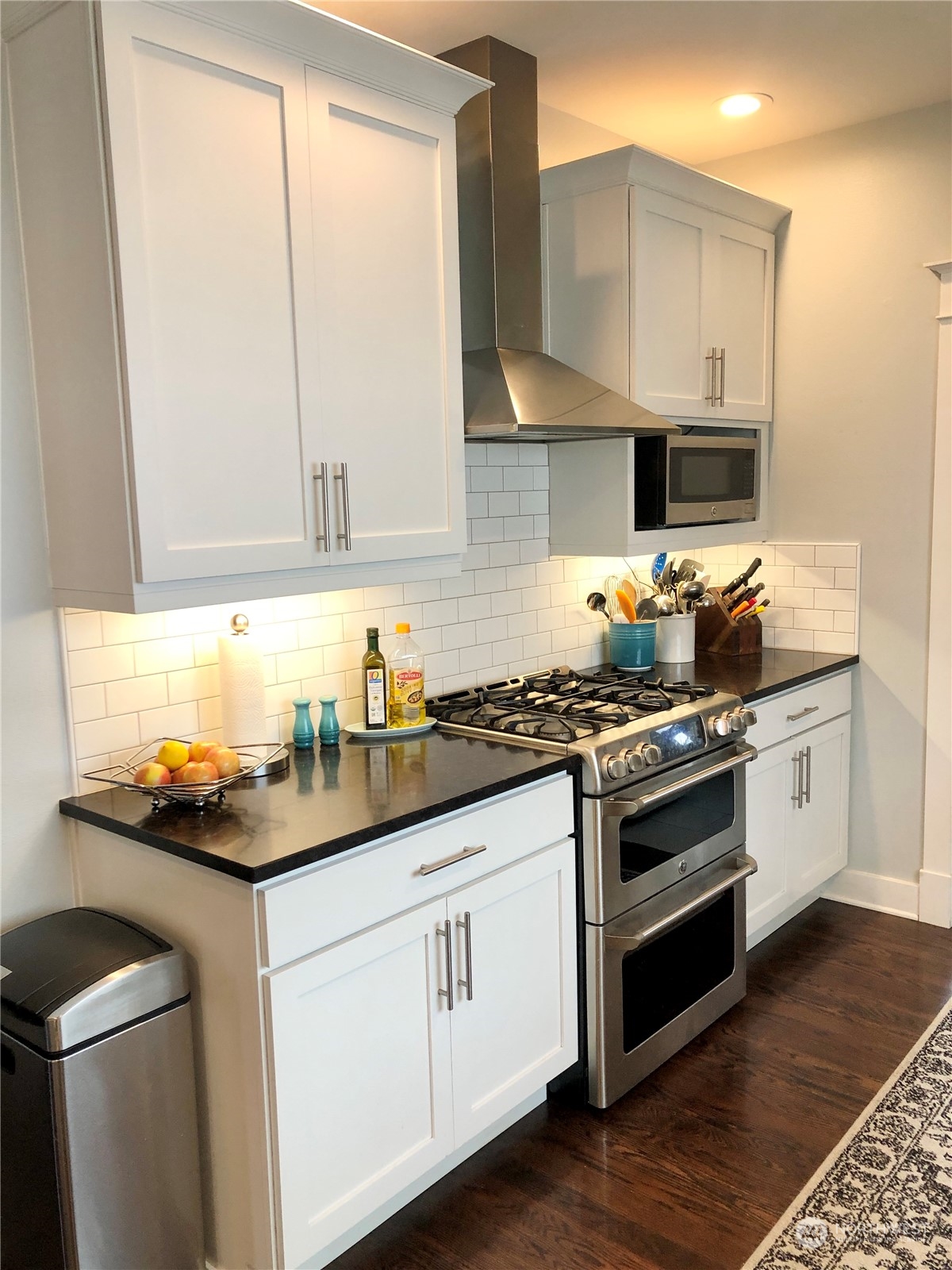 375 Southeast Bush Street Issaquah, WA 98027 - Photo 12 of 40 a kitchen with granite countertop white cabinets and white appliances