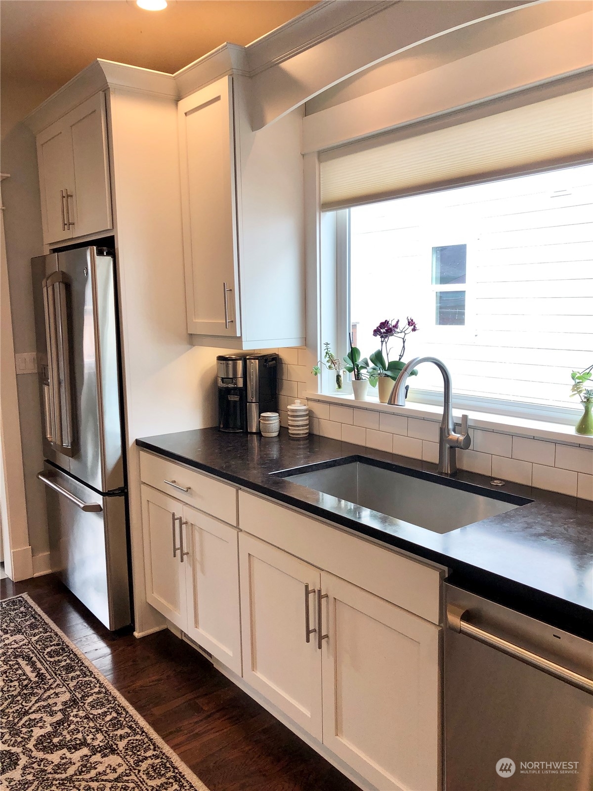 375 Southeast Bush Street Issaquah, WA 98027 - Photo 13 of 40 a kitchen with stainless steel appliances granite countertop a sink a refrigerator and a counter space