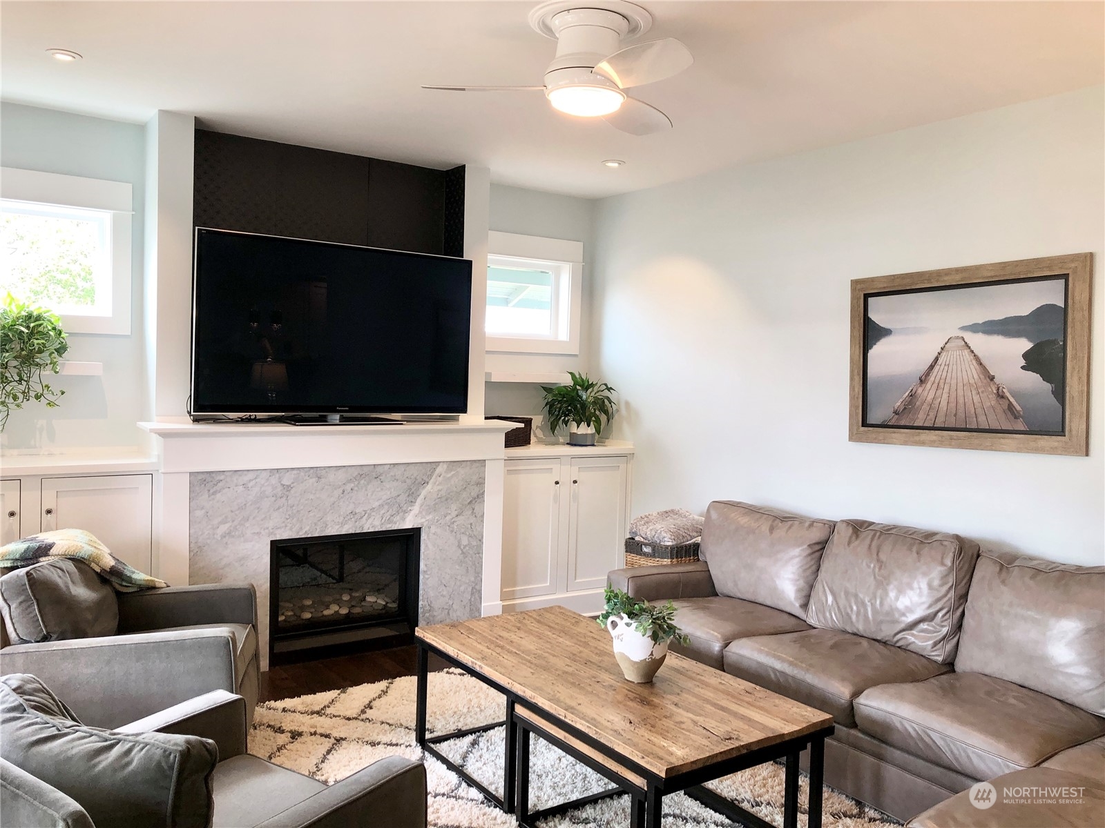 375 Southeast Bush Street Issaquah, WA 98027 - Photo 9 of 40 a living room with furniture a flat screen tv and a fireplace