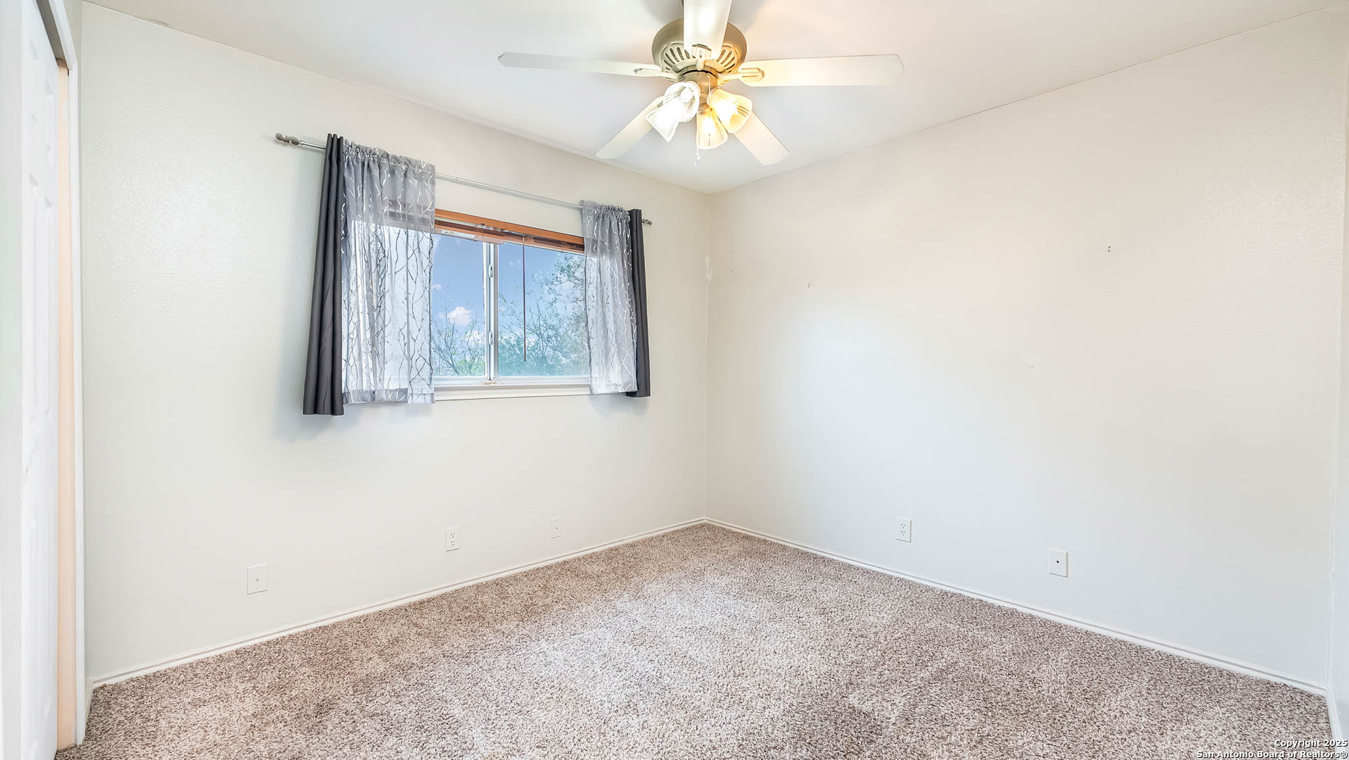 9406 San Fidel Rio San Antonio, TX 78245 - Photo 17 of 23 an empty room with a window and a fan