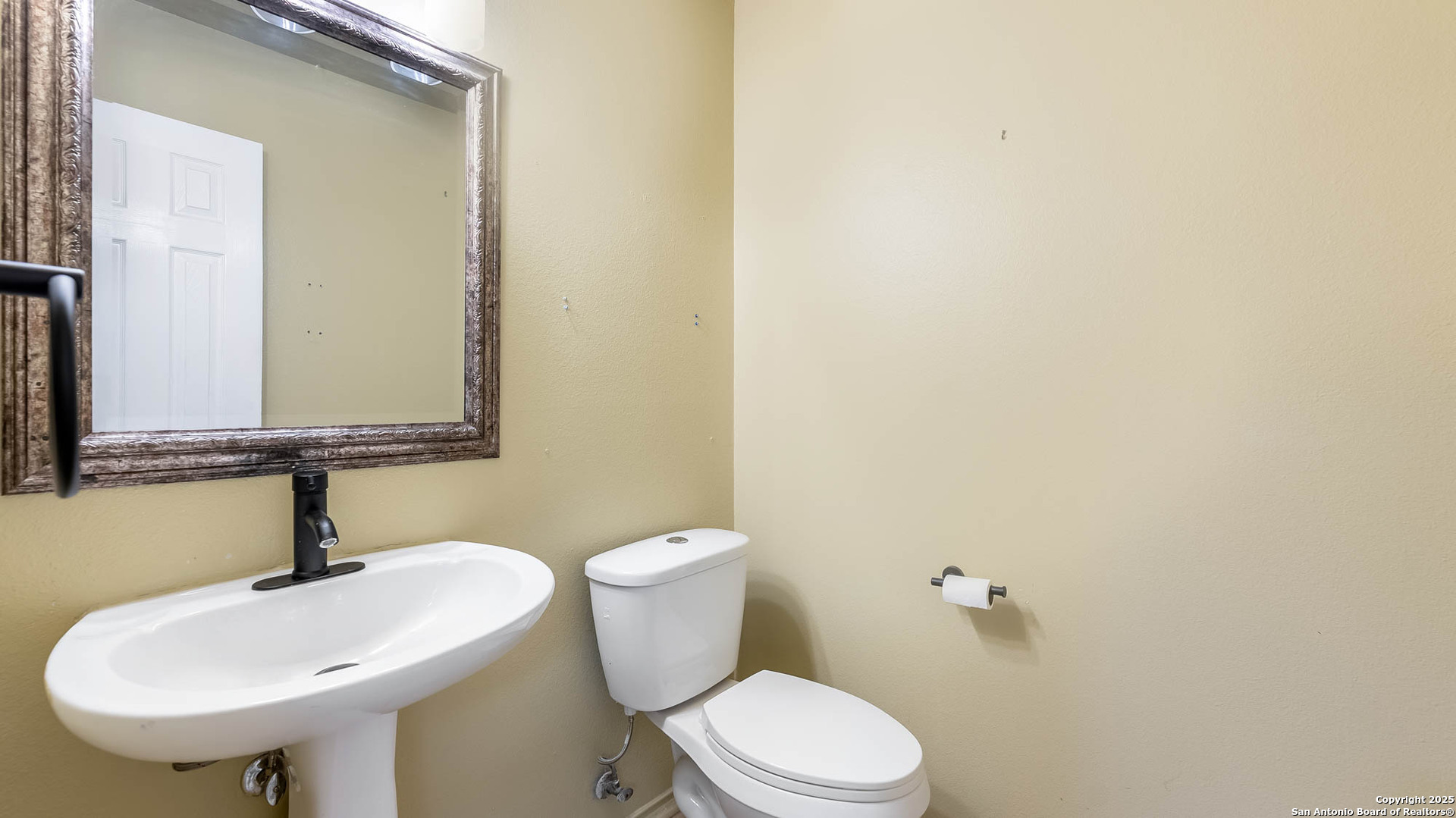 9406 San Fidel Rio San Antonio, TX 78245 - Photo 18 of 21 a bathroom with a sink a toilet and mirror