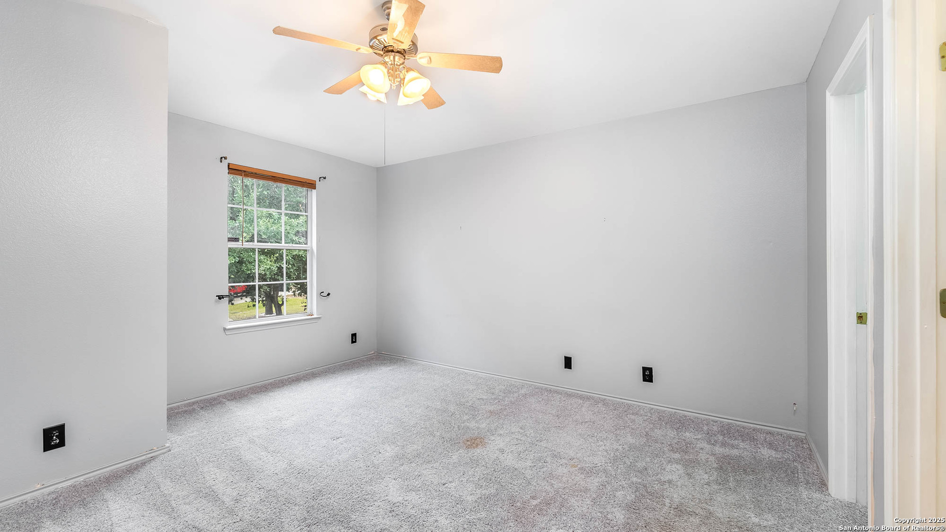 9406 San Fidel Rio San Antonio, TX 78245 - Photo 8 of 21 an empty room with windows and chandelier fan