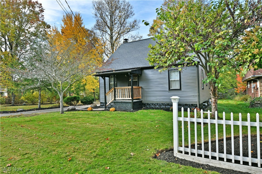 Bungalow featuring a front yard and covered porch
