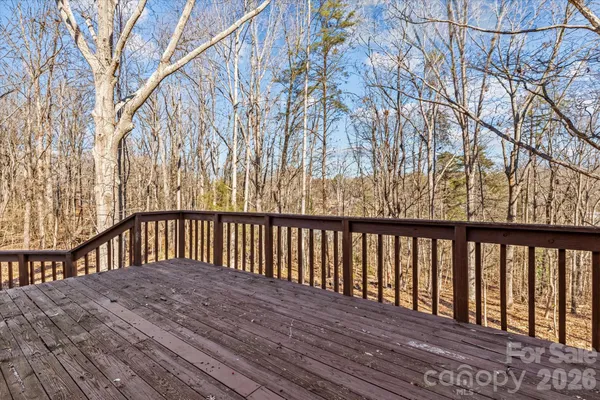 a balcony with wooden floor and fence