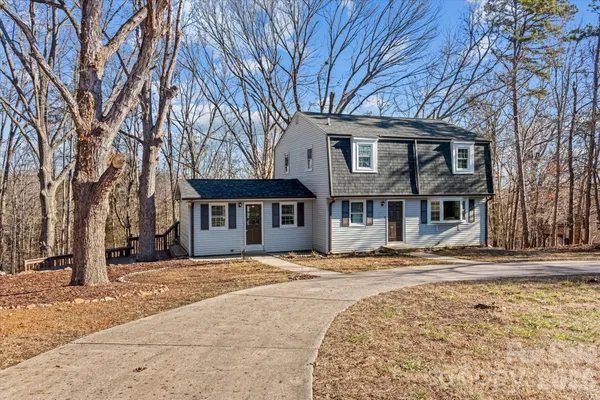 a front view of a house with a yard covered with snow