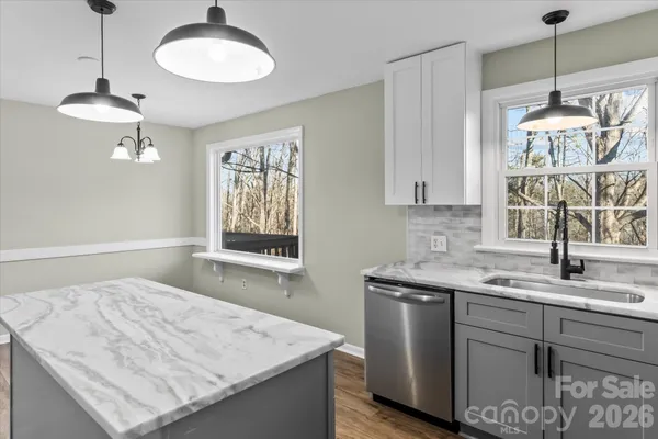 a kitchen with a sink chandelier and a stove