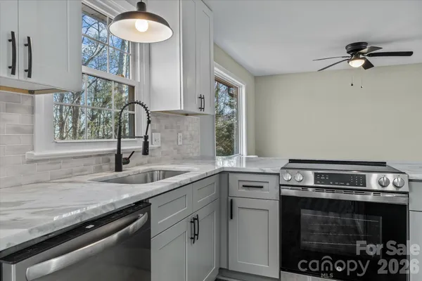 a kitchen with a sink stove and cabinets