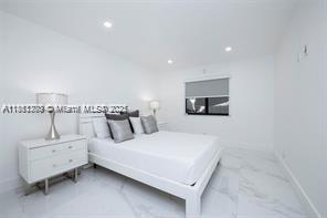 455 Northeast 210th Terrace Miami, FL 33179 - Photo 11 of 25 a bedroom with bed and a night stand