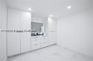 455 Northeast 210th Terrace Miami, FL 33179 - Photo 14 of 25 a kitchen with granite countertop white cabinets and white appliances