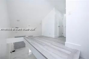 a view of an empty room and a window