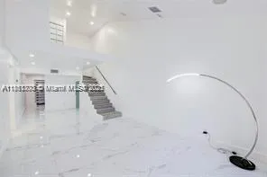 a view of an empty room with stairs