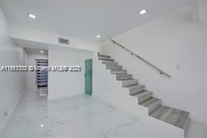455 Northeast 210th Terrace Miami, FL 33179 - Photo 4 of 25 a view of an empty room with stairs