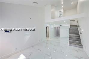 455 Northeast 210th Terrace Miami, FL 33179 - Photo 6 of 25 a view of a hallway with stairs