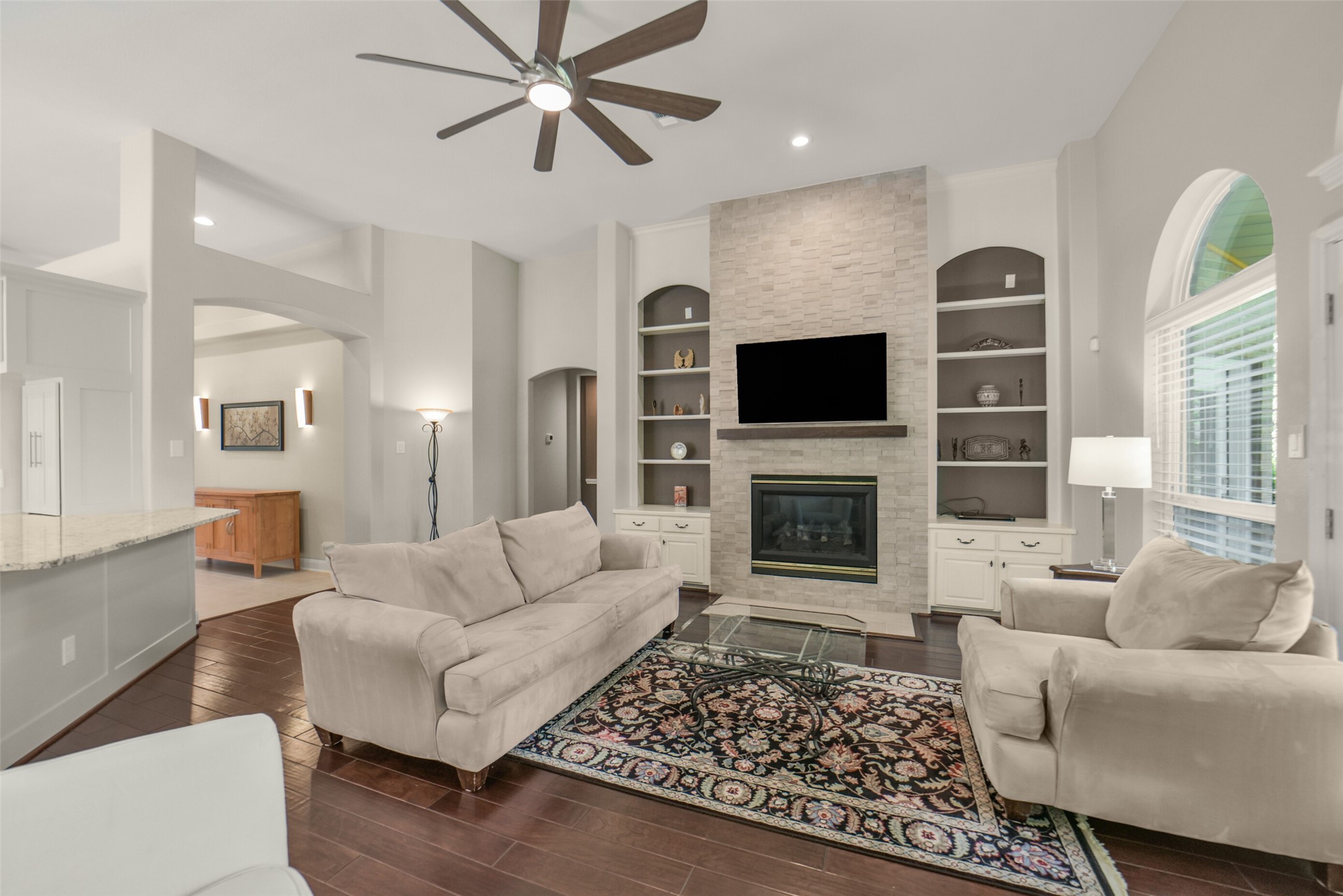 1310 Lambourne Circle Spring, TX 77379 - Photo 22 of 50 Fireplace enhanced with built-in bookshelves on each side.
