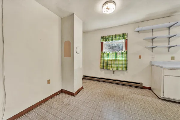 a view of an empty room with a window