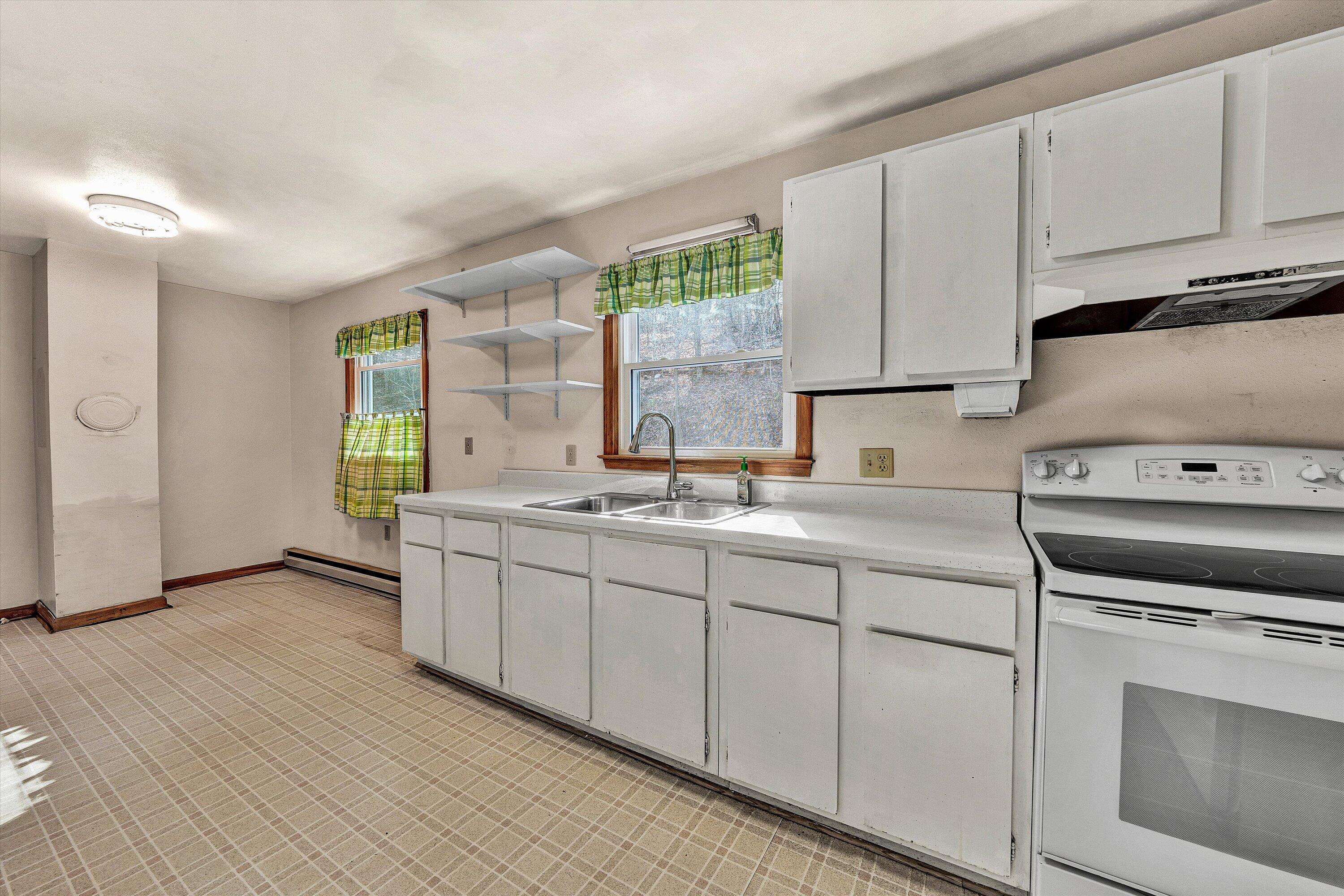 4312 Harborwood Road Salem, VA 24153 - Photo 16 of 32 a kitchen with granite countertop white cabinets and white appliances