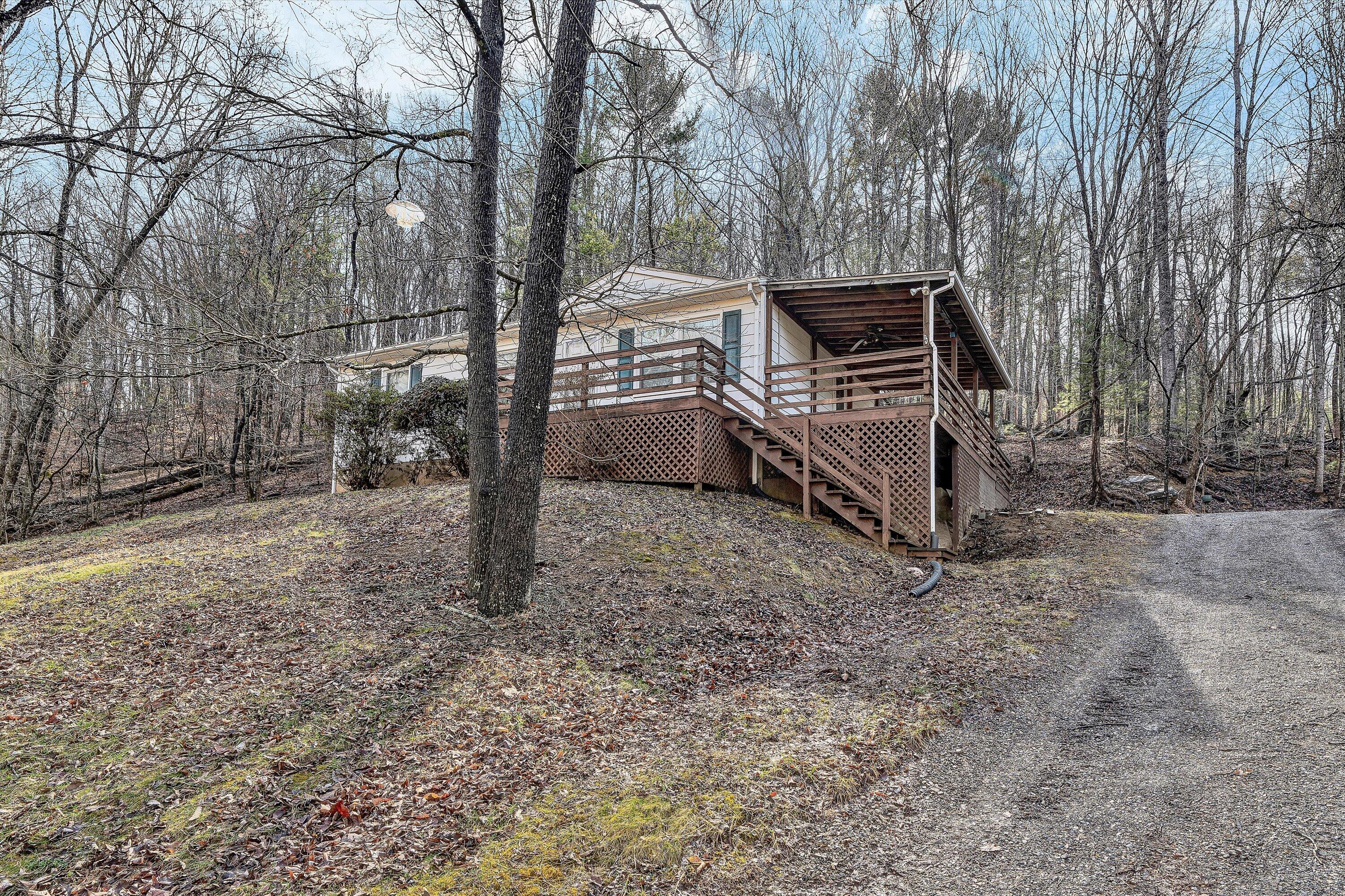 4312 Harborwood Road Salem, VA 24153 - Photo 2 of 32 a wooden bench sitting in middle of forest