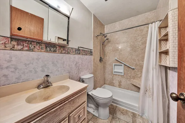 a bathroom with a sink toilet and shower
