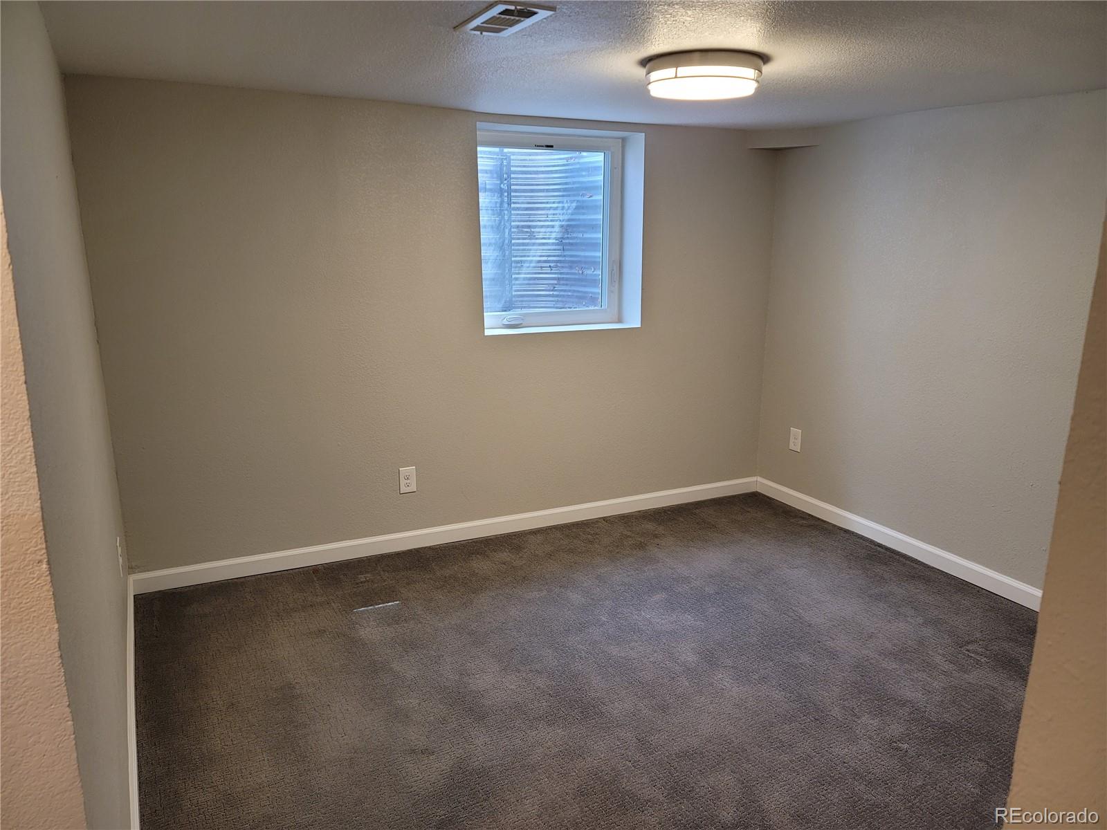 2834 Curtis Street, Unit 3 Denver, CO 80205 - Photo 21 of 22 an empty room with a window