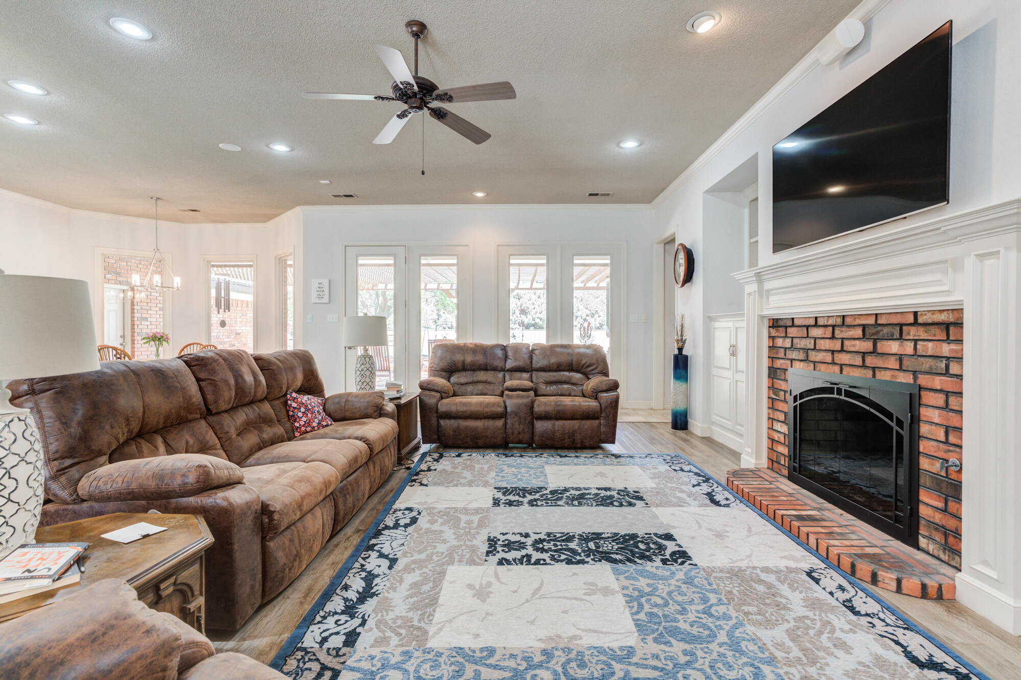 3522 156th Street Lubbock, TX 79423 - Photo 13 of 75 a living room with furniture and a fireplace