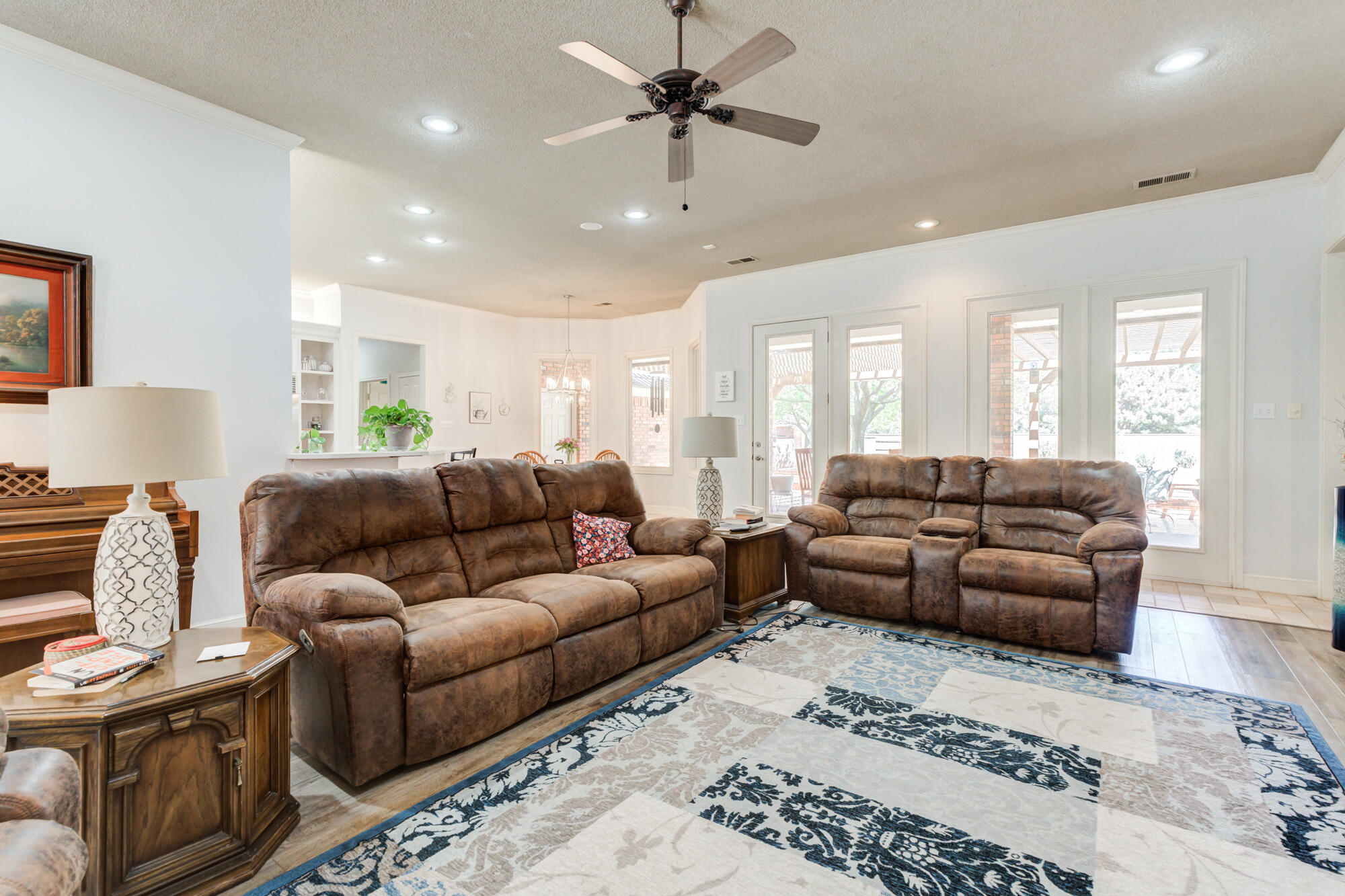 3522 156th Street Lubbock, TX 79423 - Photo 14 of 75 a living room with furniture ceiling fan and a rug
