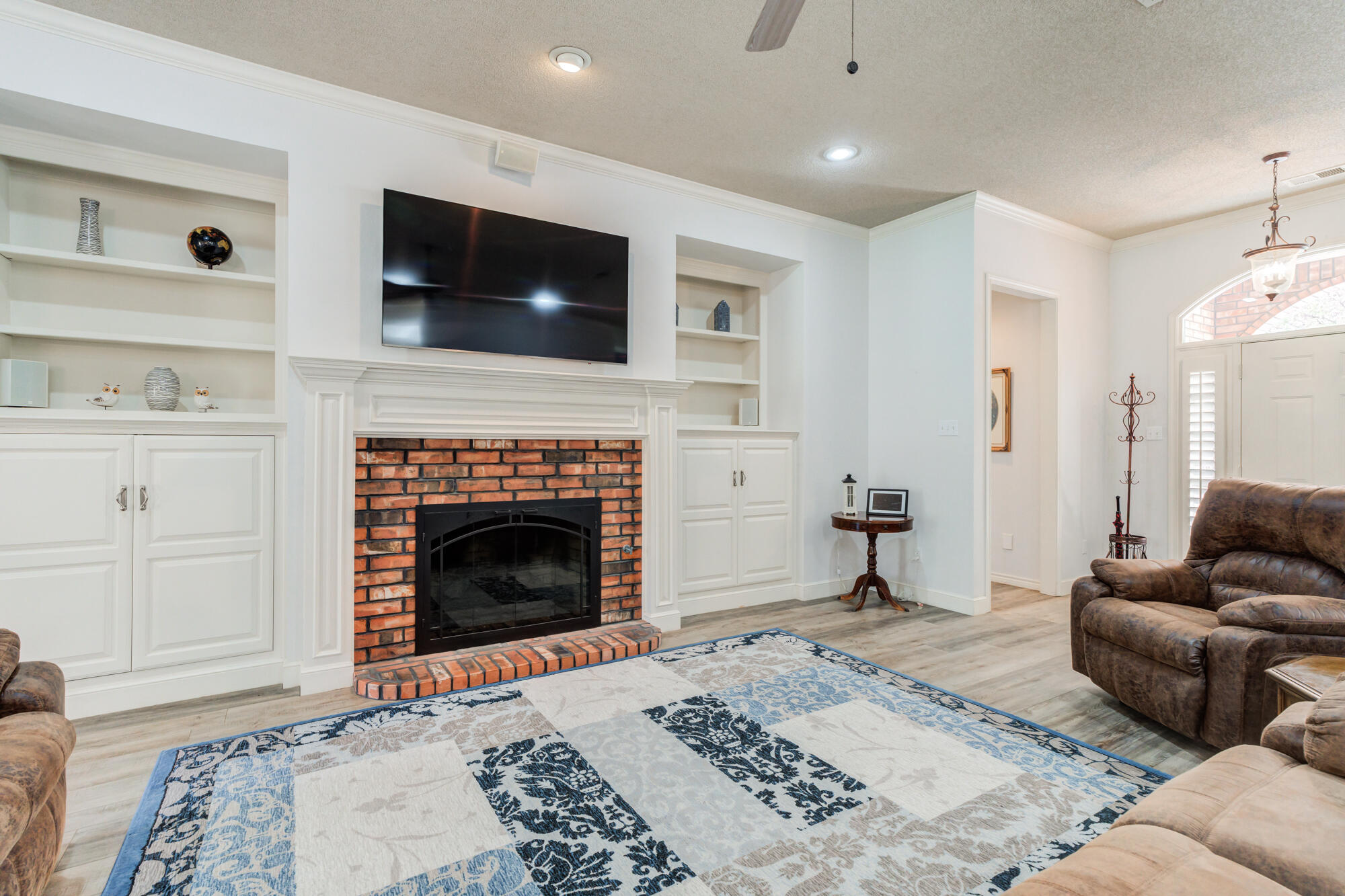 3522 156th Street Lubbock, TX 79423 - Photo 18 of 75 a living room with furniture and a fireplace