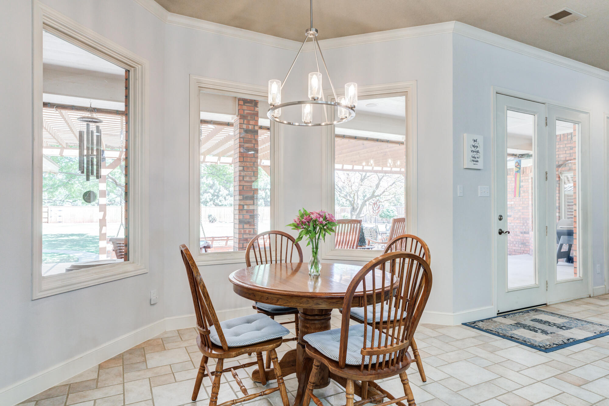 3522 156th Street Lubbock, TX 79423 - Photo 22 of 75 a dining room with furniture a chandelier and wooden floor