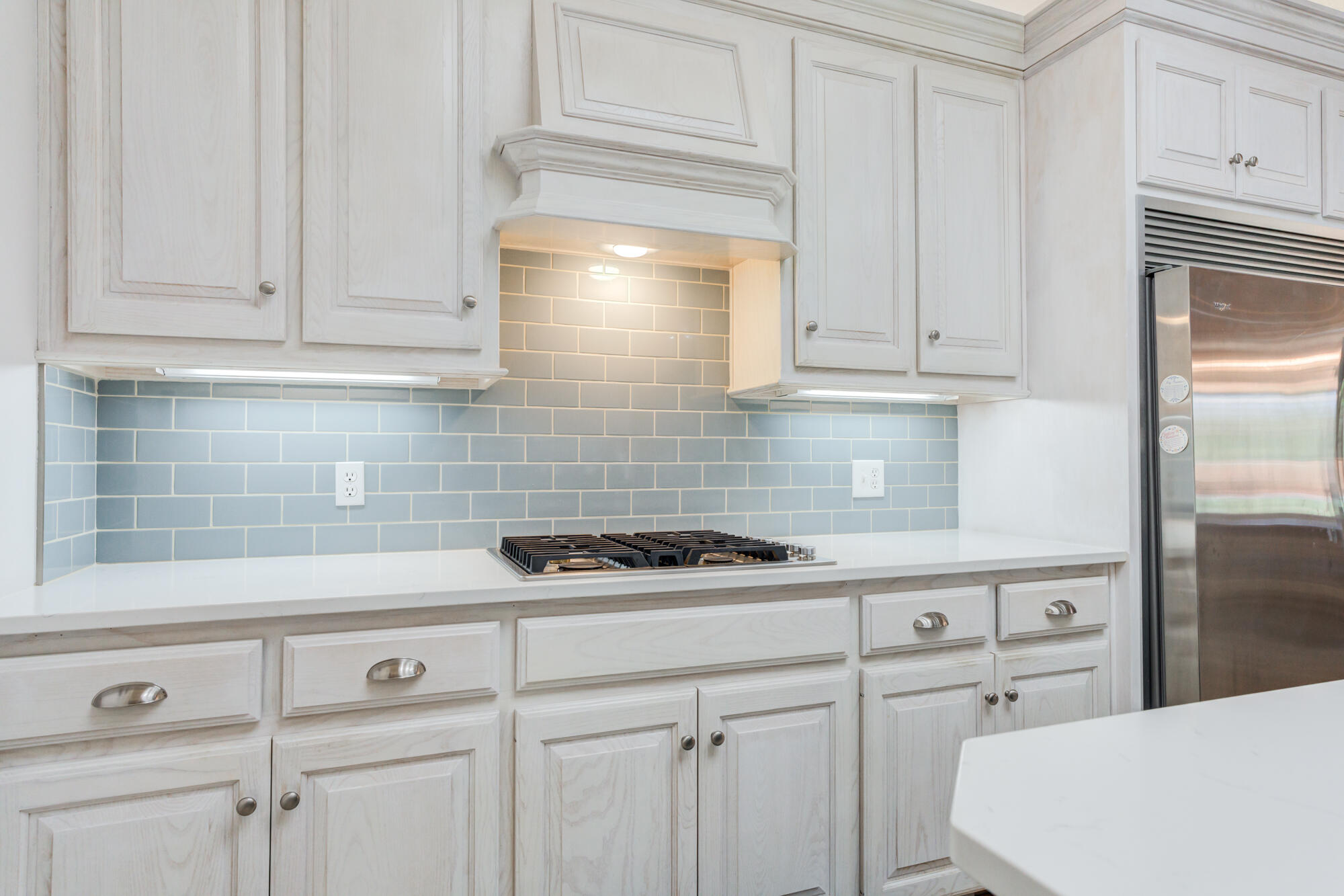3522 156th Street Lubbock, TX 79423 - Photo 29 of 75 a kitchen with white cabinets and a stove