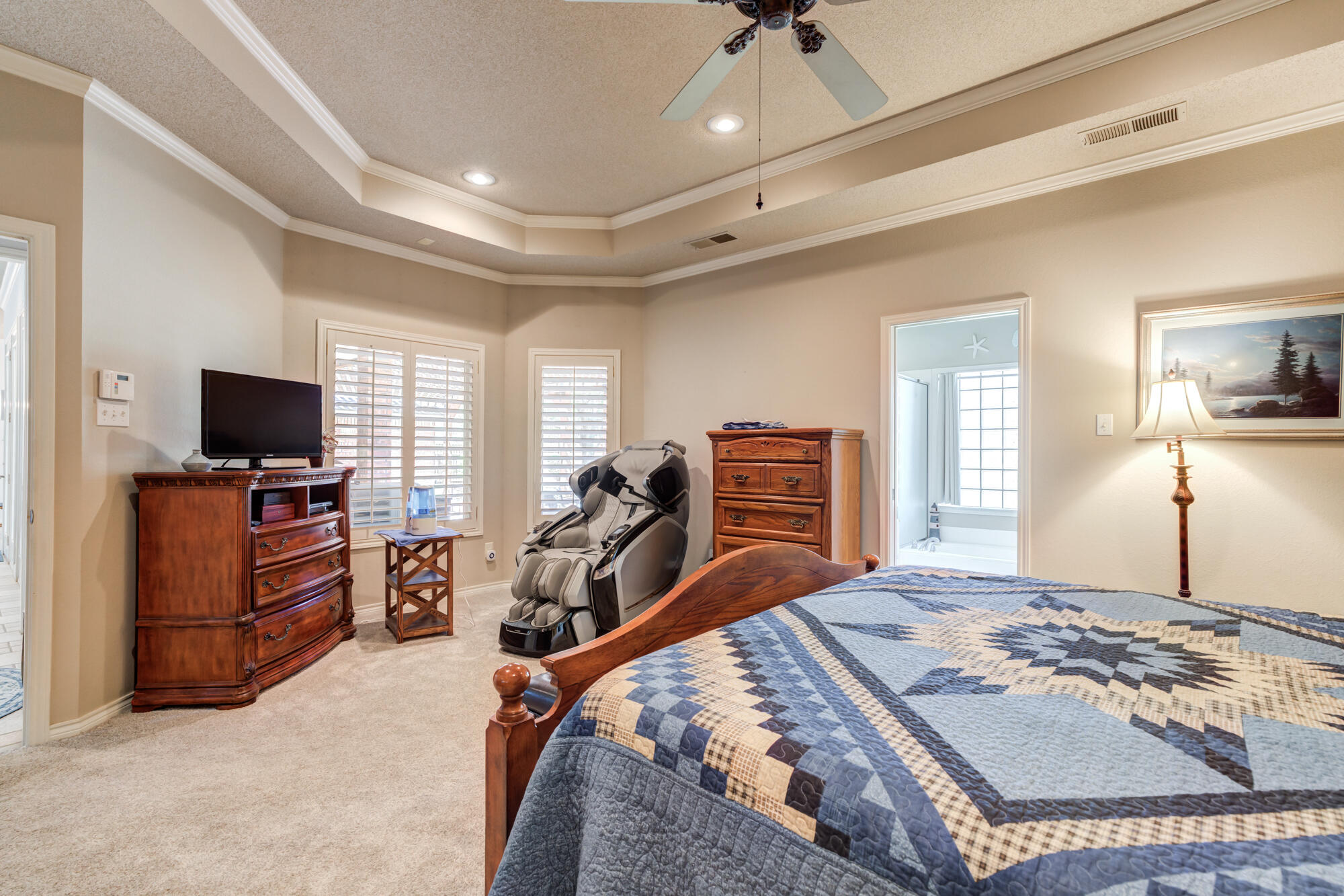 3522 156th Street Lubbock, TX 79423 - Photo 34 of 75 a bedroom with furniture and a flat screen tv