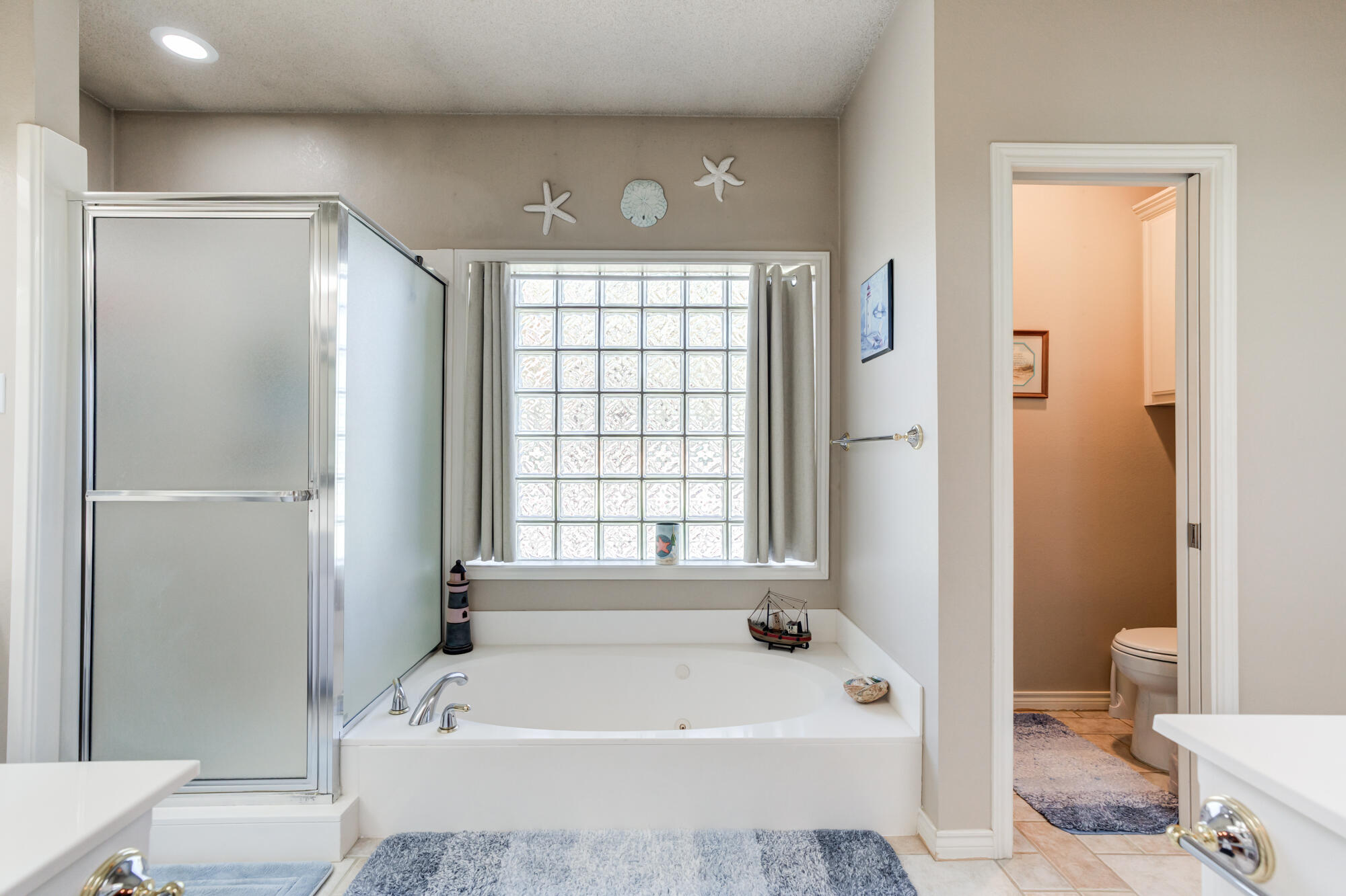 3522 156th Street Lubbock, TX 79423 - Photo 35 of 75 a bathroom with a bathtub a toilet and a shower
