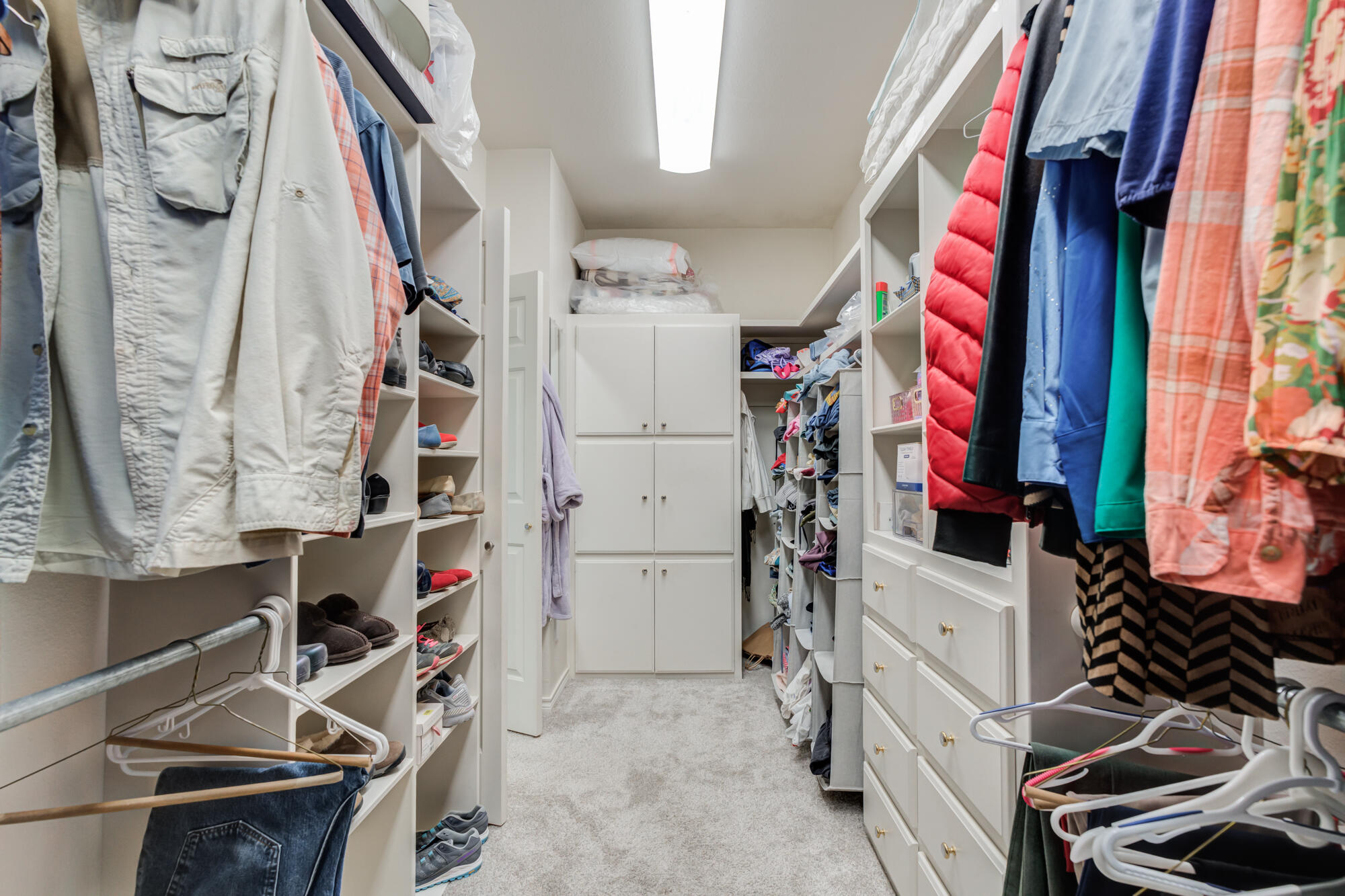 3522 156th Street Lubbock, TX 79423 - Photo 38 of 75 a view of walk in closet with clothes and shoes