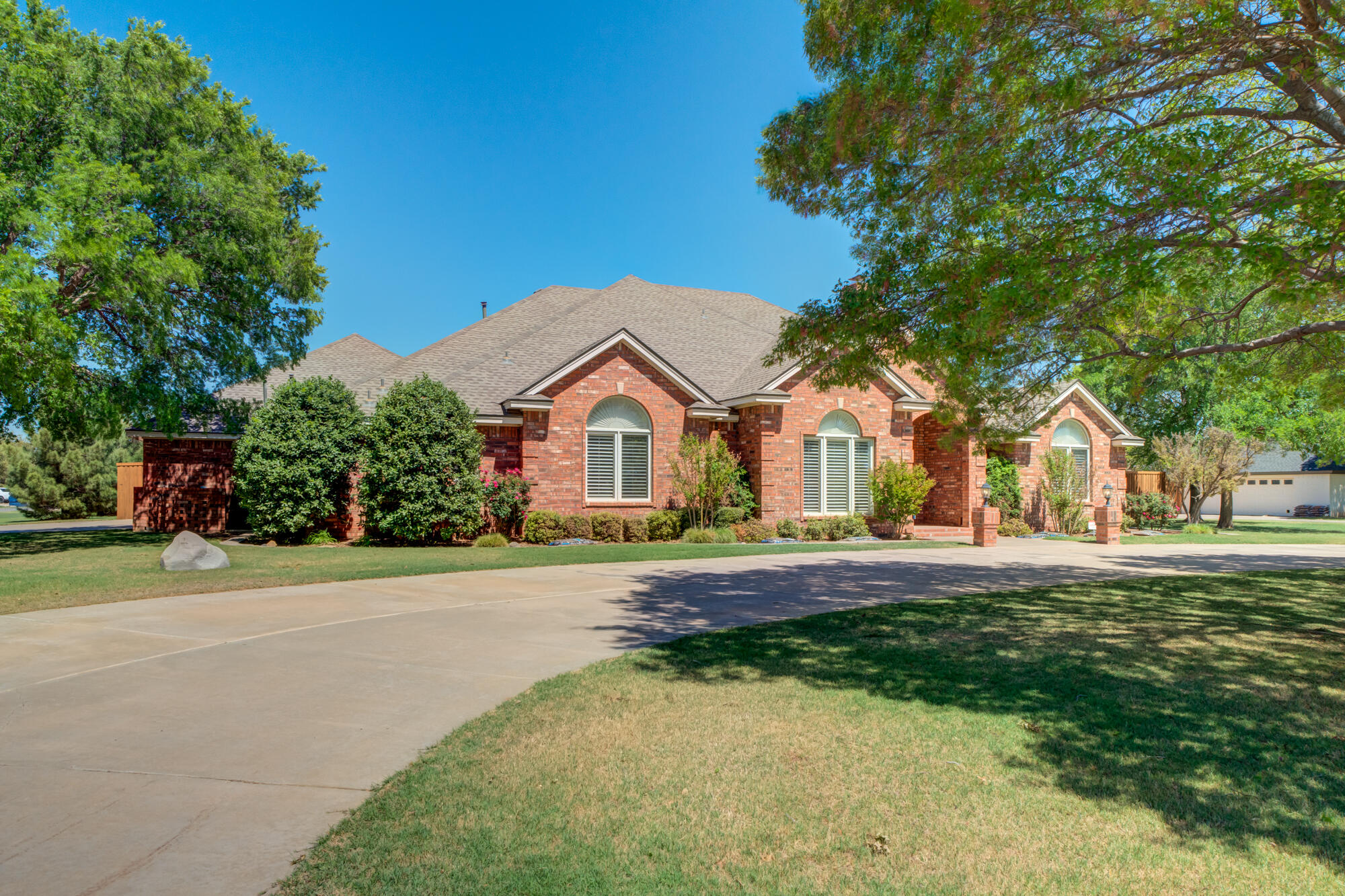 3522 156th Street Lubbock, TX 79423 - Photo 5 of 75 a front view of a house with a yard and garage
