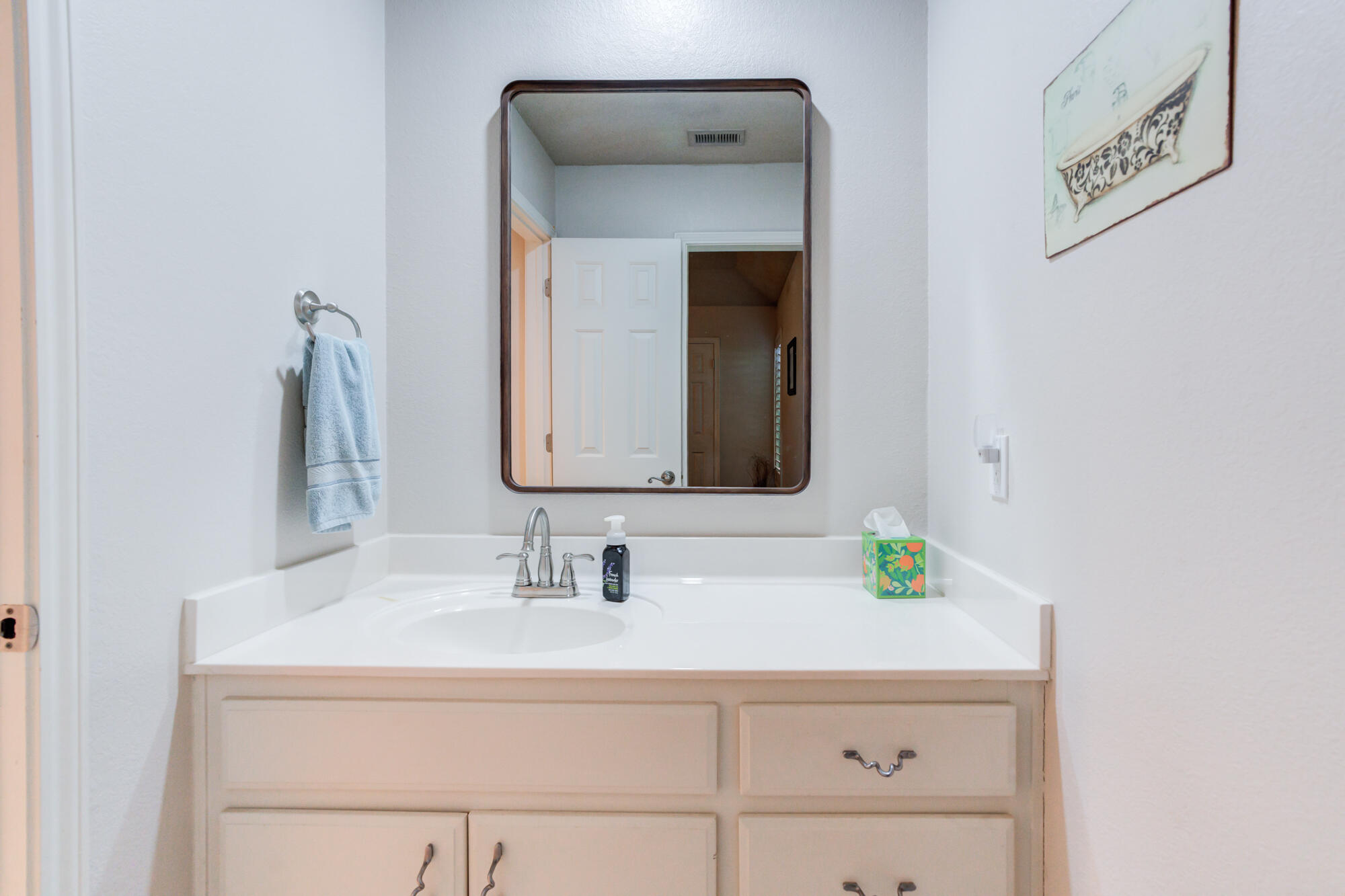 3522 156th Street Lubbock, TX 79423 - Photo 51 of 75 a bathroom with a sink and a mirror