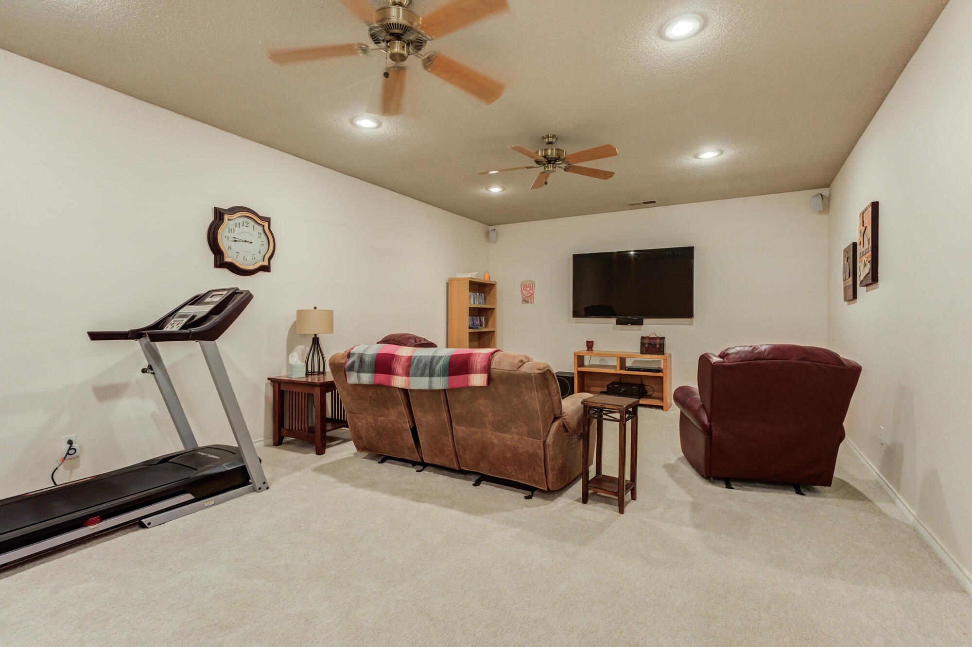 3522 156th Street Lubbock, TX 79423 - Photo 53 of 75 a living room with furniture and a flat screen tv