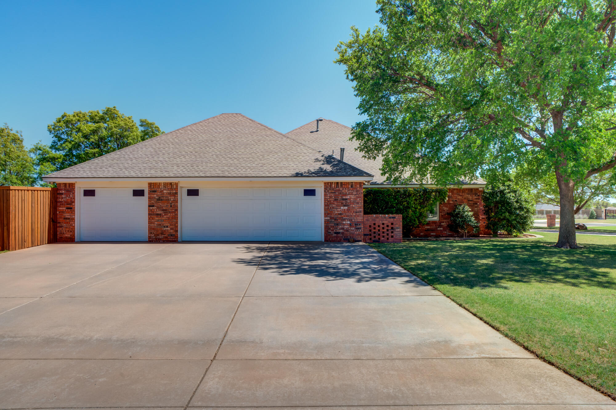 3522 156th Street Lubbock, TX 79423 - Photo 6 of 75 a front view of a house with a garden and trees