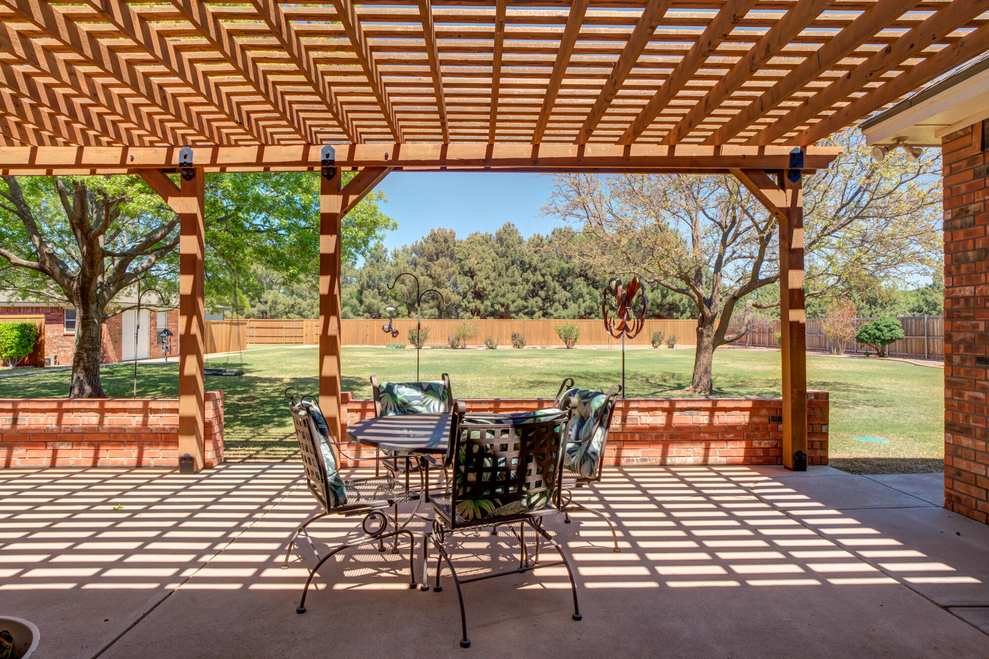 3522 156th Street Lubbock, TX 79423 - Photo 62 of 75 a view of a patio with a table and chairs next to a yard
