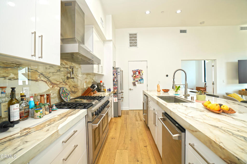 6565 Pickwick Street Los Angeles, CA 90042 - Photo 14 of 41 a kitchen with stainless steel appliances a sink stove and cabinets