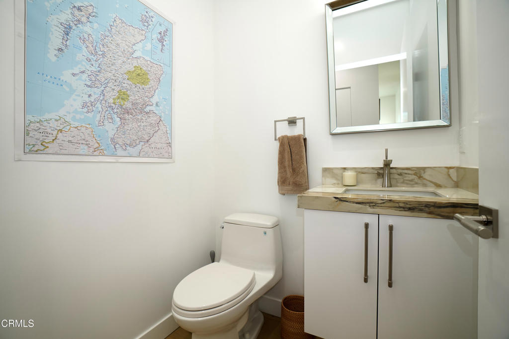 6565 Pickwick Street Los Angeles, CA 90042 - Photo 15 of 41 a bathroom with a granite countertop toilet sink and mirror