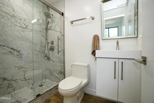 a bathroom with a toilet and a shower