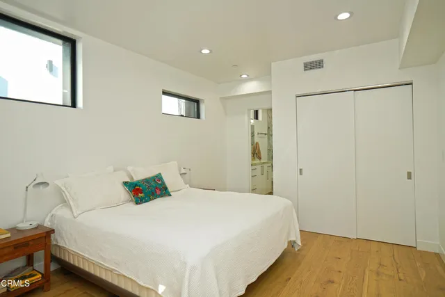 a bedroom with a bed and a window