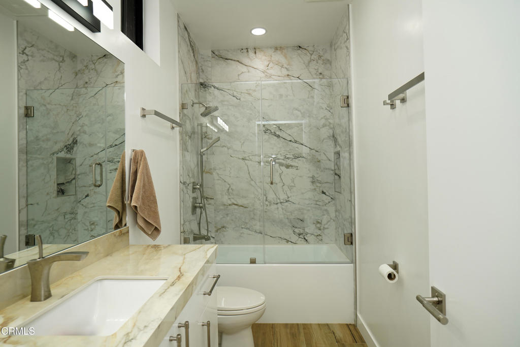 6565 Pickwick Street Los Angeles, CA 90042 - Photo 26 of 41 a bathroom with a granite countertop bathtub shower sink vanity and toilet
