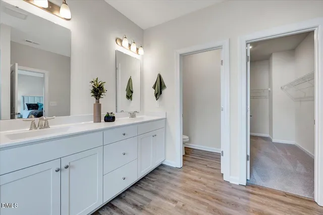 a bathroom with a double vanity sink and a mirror