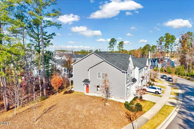 an aerial view of a house with a garden and lake view