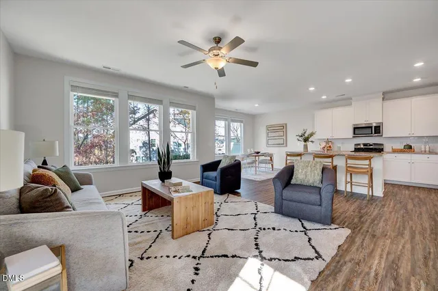a living room with furniture and kitchen view