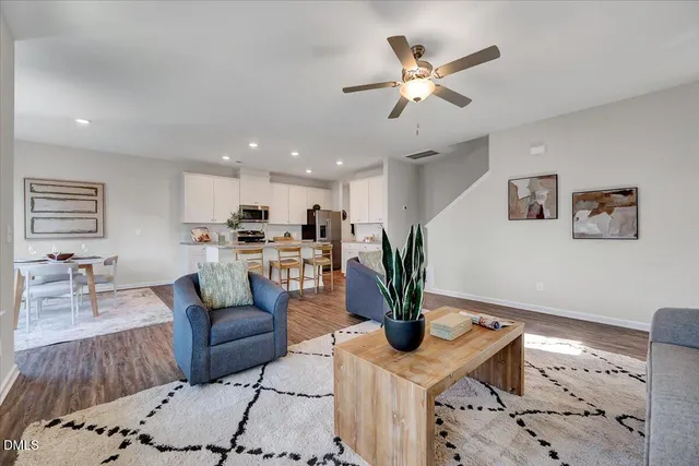 a living room with furniture and kitchen view